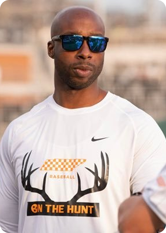 Man in white Nike Tennessee Baseball "On The Hunt" shirt and blue mirrored sunglasses outdoors