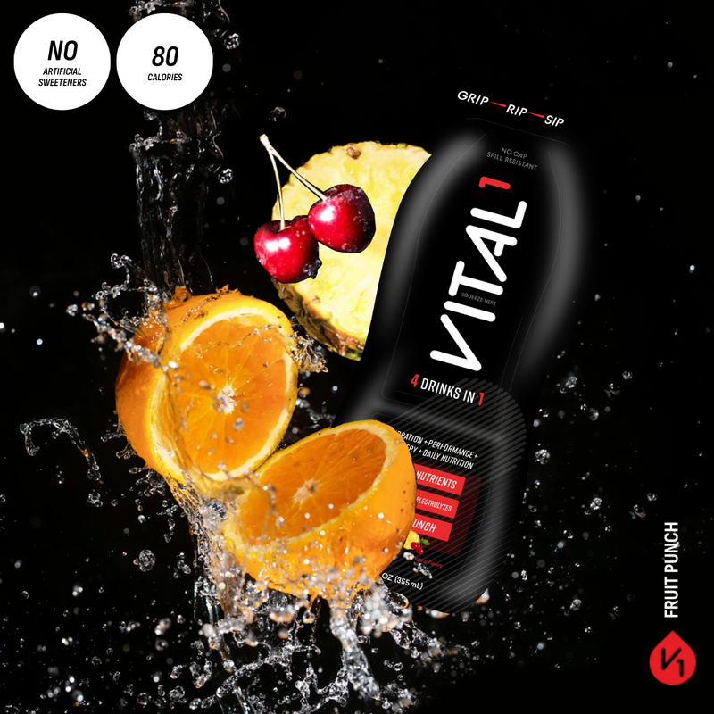 Vital1 Fruit Punch pouch, "4 Drinks in 1," 80 calories, no artificial sweeteners, surrounded by splashing oranges, cherries, and pineapple on black background.