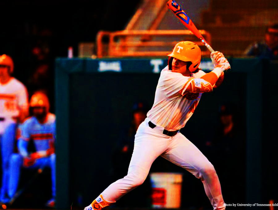 Tennessee Volunteers baseball player in orange helmet and white uniform mid-swing at bat